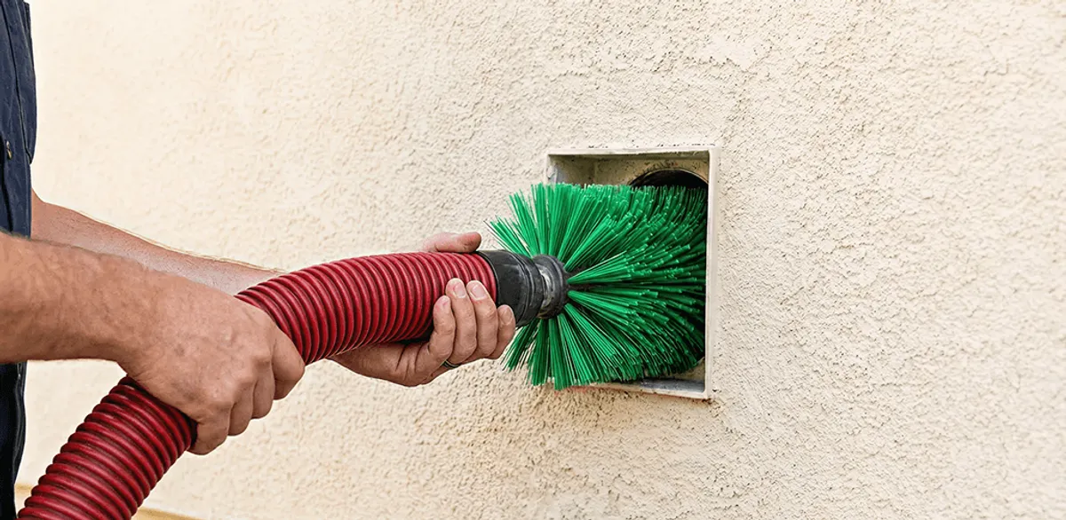 Air duct cleaning brush removing debris from a vent opening in Jackson, MS