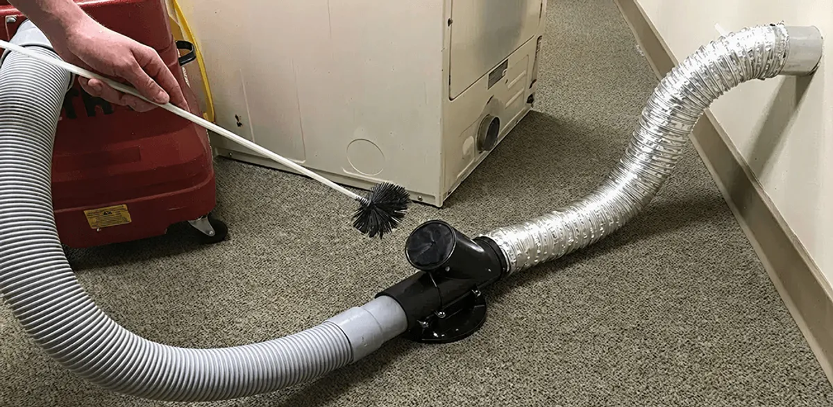 Dryer vent cleaning service removing lint from a dryer duct connection in Jackson, MS