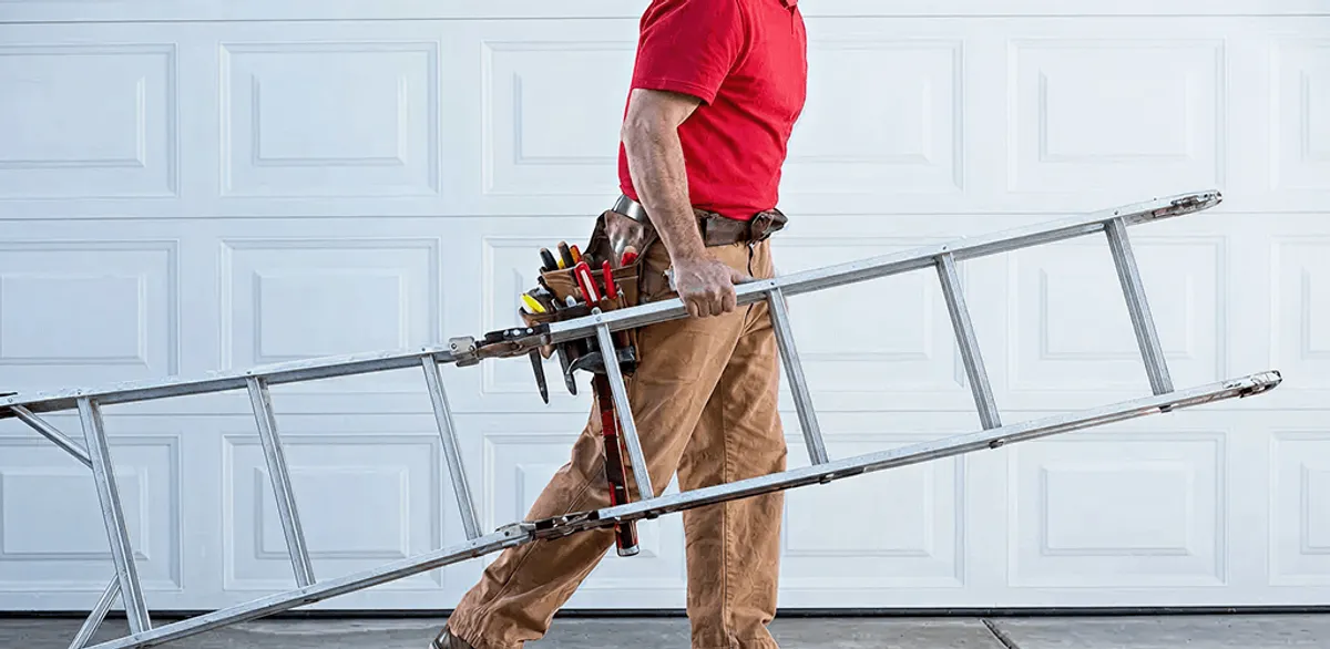 Garage door repair technician arriving with tools and ladder in Jackson, MS