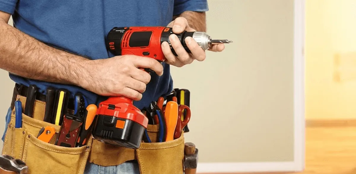 Handyman holding a power drill for home repairs and installations in Jackson, MS