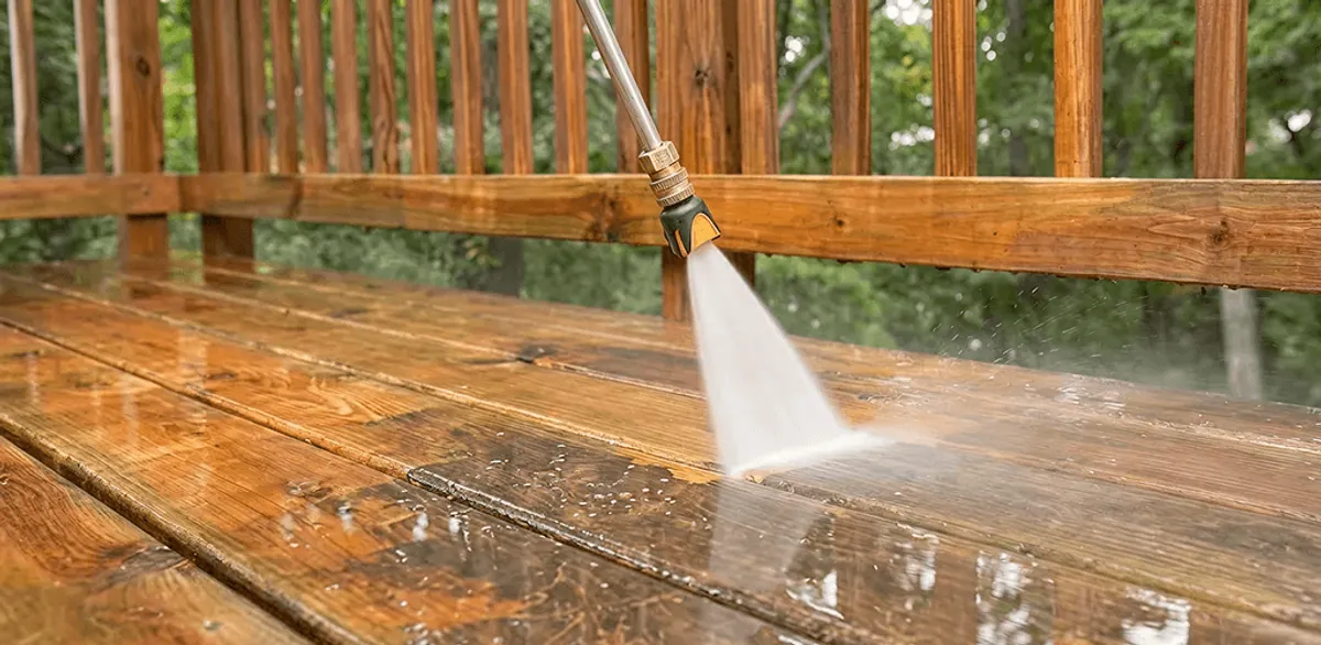 Pressure washing a wood deck to remove dirt and buildup in Jackson, MS